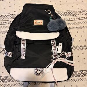 Black and White Backpack with Pom Pom Charm